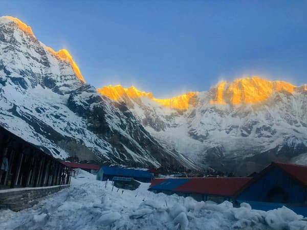 Golden Sunrise Casting Warm Light –on Snow Capped Himalayan Peaks At Annapurna Base Camp